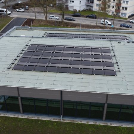 Energetische Sanierung Schwimmbad Teilansicht der PVT-Flachdachanlage von oben Copyright Giersch